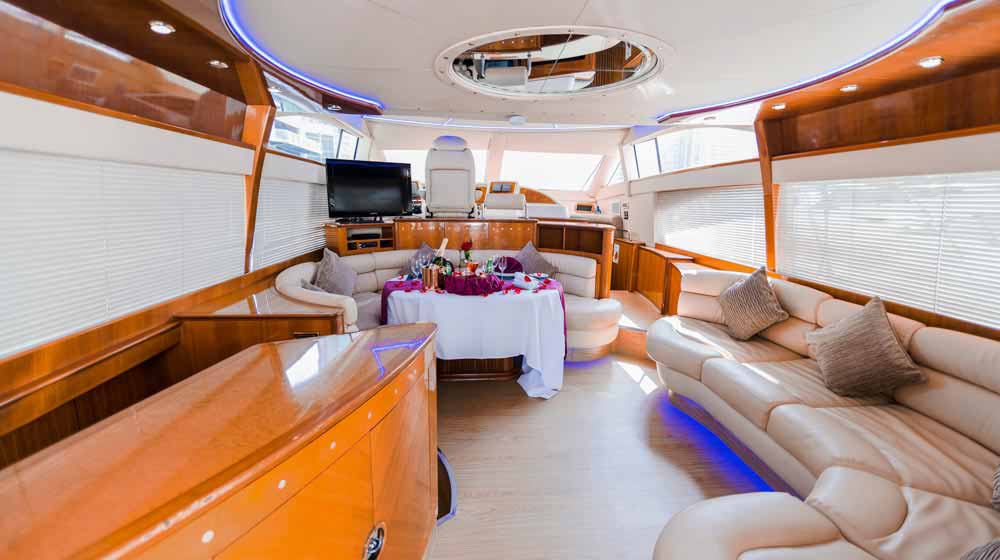 yacht with spacious living area with comfy sofas, ceiling lights, big windows